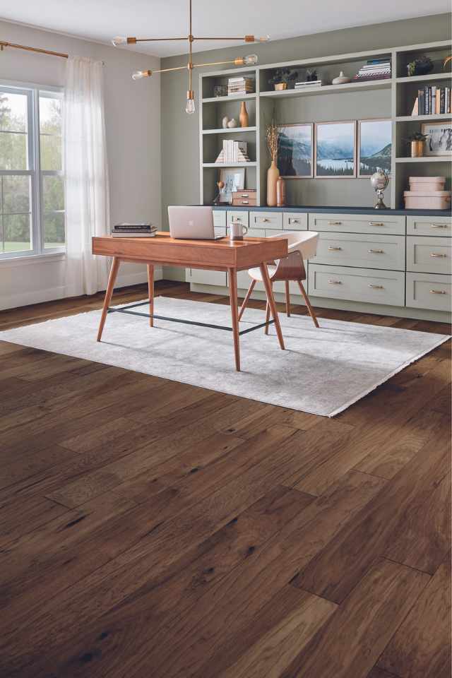 dark stained hickory hardwood in home office with sage green walls and area rug